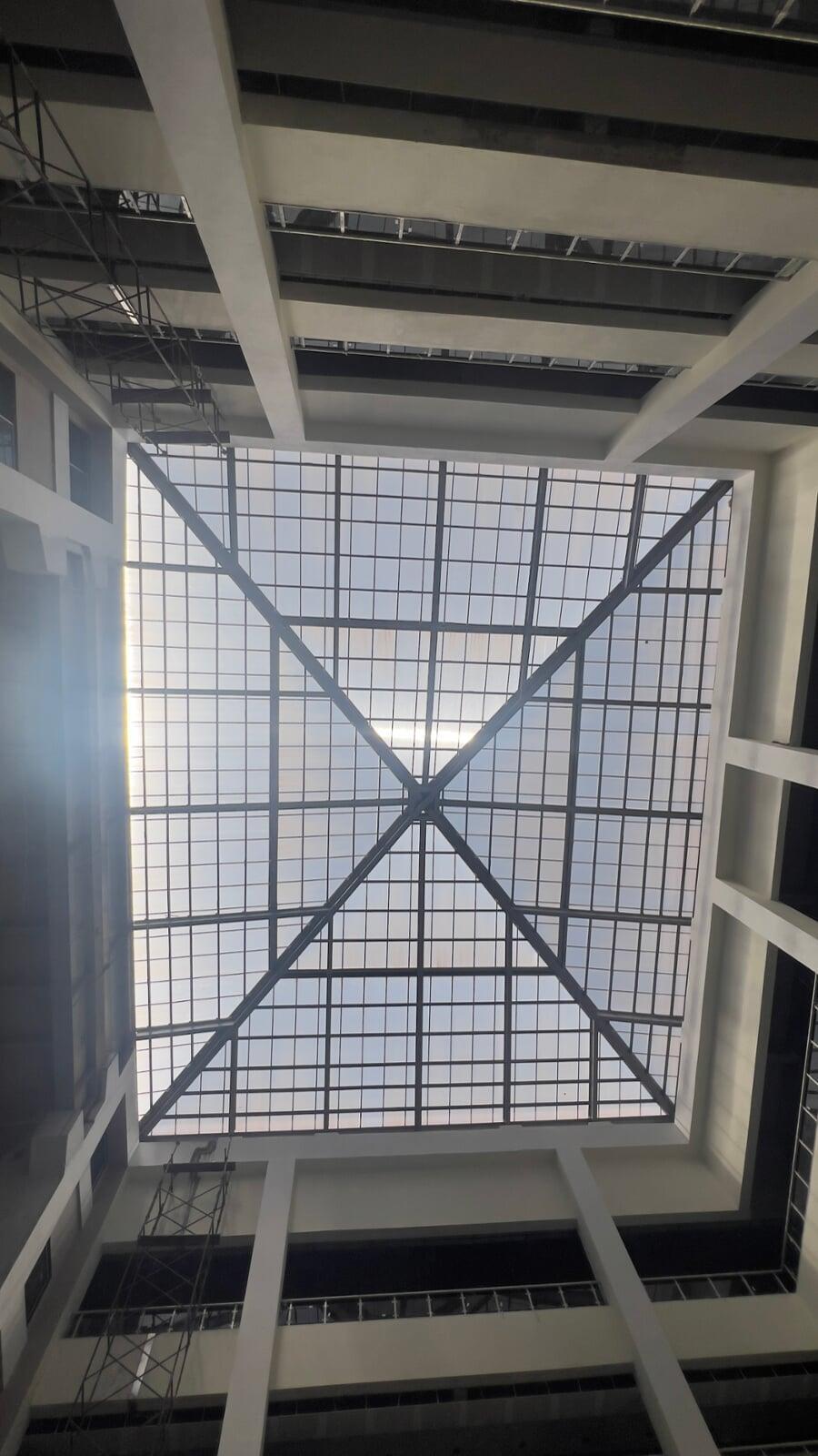 Commercial architectural roofing at Oberoi Mall, Mumbai: Specialized Kliplok roof-on-roof installation by Rishonn & Reyansh for leak-proof retail infrastructure.